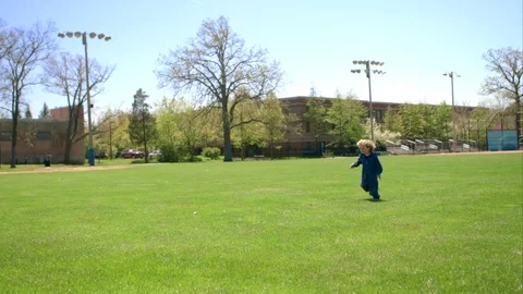 The boy runs along the grass Stock-Footage 75979732