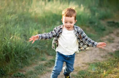 Boy runs along the path on camera Stock Photos