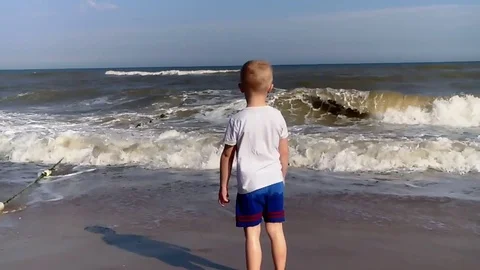 The boy runs around the sea Stock Footage 80446716