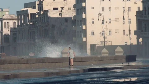 The boy runs away from large waves. Stock Footage 72493176