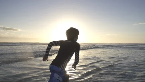 Boy runs on beach sunset Stock Footage 97898893