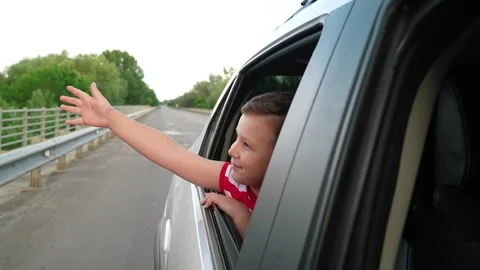 Boy s window adventure, Simple travel pleasures, Childhood memories in car Stock Footage 312235624