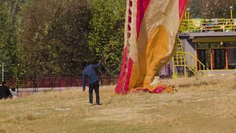 A Boy Safely Descending with a Parachute Grasped by Wires at Bir Billing 스톡 동영상 256141702