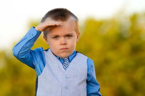 Boy saluting to the camera Stock Photos
