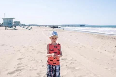 Boy on sandy beach Stock Photos
