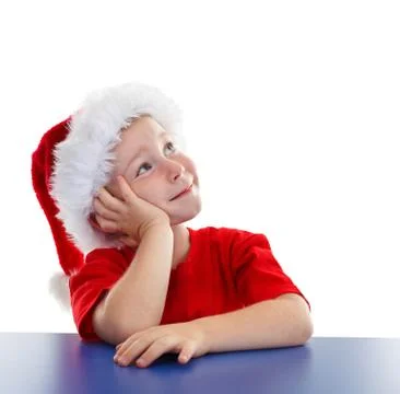 Boy in santa hat, looking to copy space Stock Photos