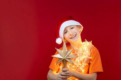 A boy in a Santa hat on a red background Foto stock