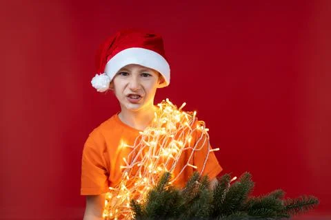A boy in a Santa hat on a red background Stock-Fotos