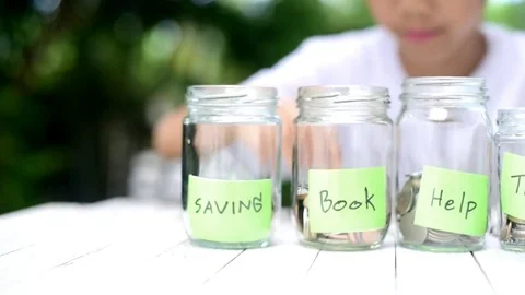 Boy saving coin and zoom to out focus Stock Footage 81028249