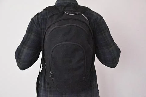 The boy with school backpack. Shot from behind. Stock Photos