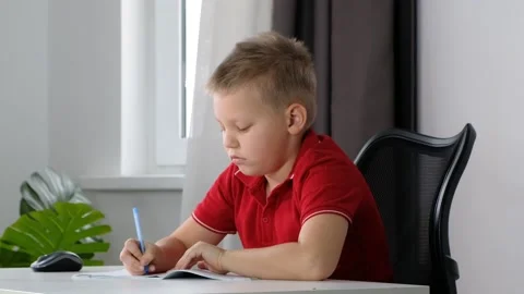 The boy School child doing his homework at home and feeling tired, sleepy and Stock Footage 171157666