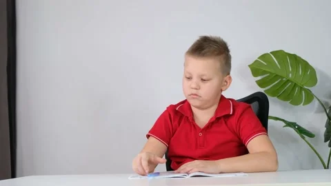 The boy School child doing his homework at home and feeling sleepy and bored Stock Footage 172020649