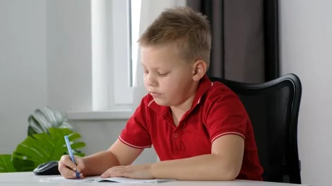 The boy School child doing his homework at home Video stock 189866580