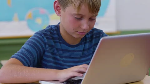 Boy in school classroom using laptop computer 스톡 동영상 68962163