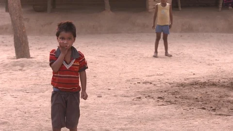 Boy on the school ground eating a fruit 動画素材 90858640