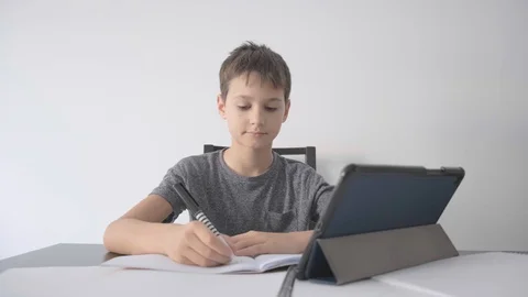 Boy school homework, using tablet computer at home Stock Footage 127780217