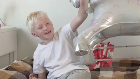 A boy is a schoolboy and a large unicorn balloon. Stock Footage 157148930
