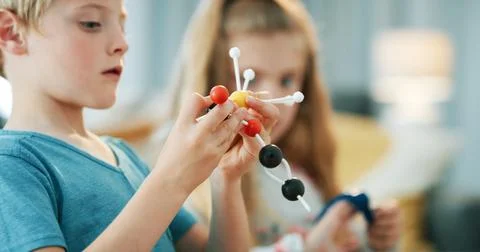 Boy, science and play with atom model for project, discovery or assignment... Stock Photos