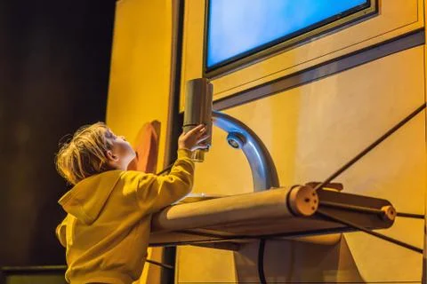 Boy in science class with electron microscope Stock Photos