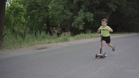 Boy on scooter Stock Footage 111832619
