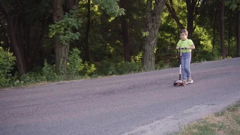 Boy on a scooter Stock Footage 111833263