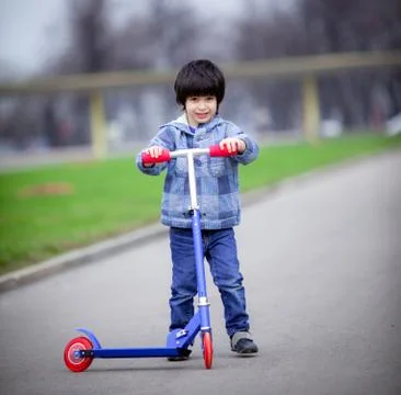 Boy with scooter Stock Photos