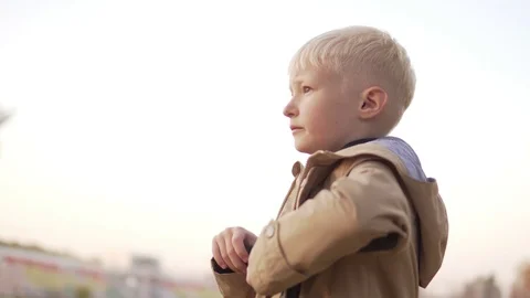 Boy on a scooter stopped to watch the sunset. Stock Footage 96970615