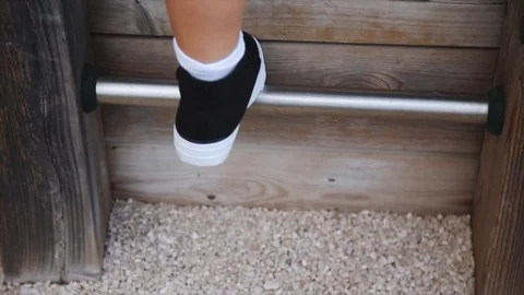 The boy scrambles up the stairs in the playground Stock Footage 102039292