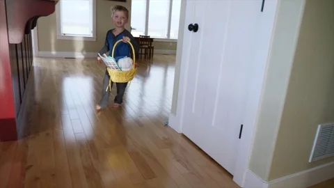 Boy searches for his easter eggs sunday morning Stock Footage 75769673