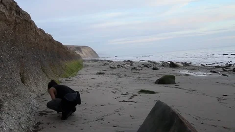 Boy searching for shells Stock Footage 83164653