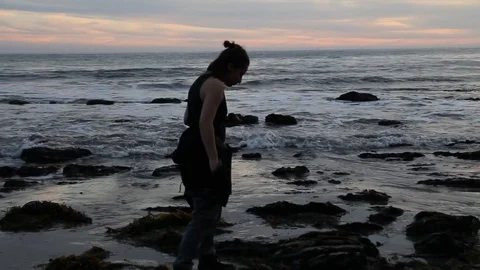 Boy searching for shells at sunset Stock Footage 83175417