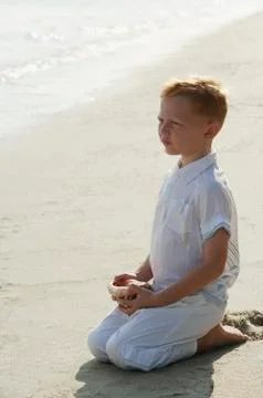 Boy with seashell Stock Photos