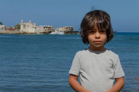 Boy on the seashore in a bay Stock Photos