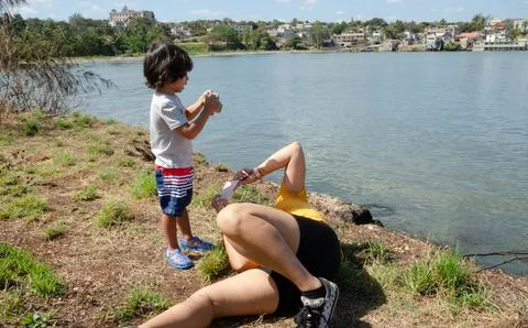 Boy on the seashore photographing model Stock Photos