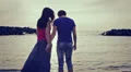 a boy on the seashore at sunset hugs her girlfriend and jokes with water HD Footage