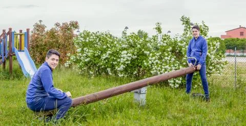 Boy on seesaw Stock Photos