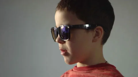 A boy with a serious face and dark glasses 4K Video stock 126806927