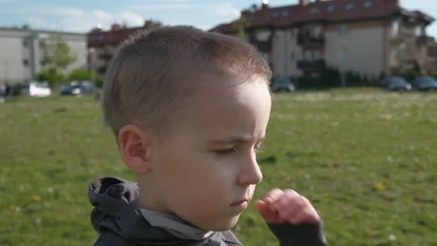 A boy with a serious look wears a protective mask outdoor Stock Footage 131101180
