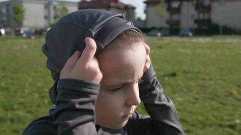 A boy with a serious look wears a protective mask outdoor Stock Footage 131101420
