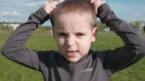 A boy with a serious look wears a protective mask outdoor Stock Footage 131101555