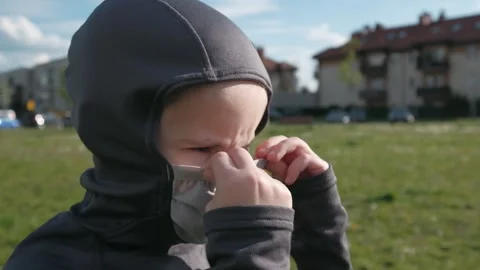A boy with a serious look wears a protective mask outdoor Stock Footage 131101969