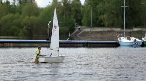 Boy sets sail on a boat with a sail Stock Footage 54028355