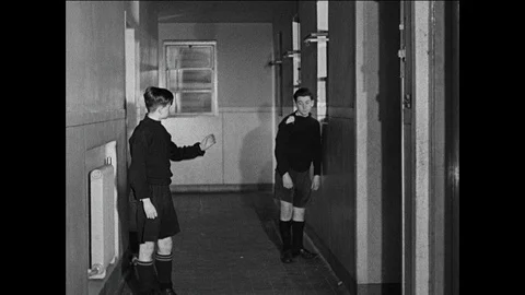 Boy settles himself in the new boarding school facilities, UK 1944 Vídeos de archivo 139237091