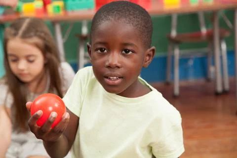 Boy sharing a plastic ball Foto stock