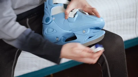 Boy is Sharpening his figured skates manually, ice-skating shoe preparing Stock Footage 100303908