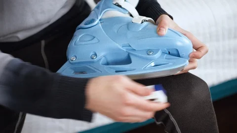 Boy is Sharpening his figured skates manually, ice-skating shoe preparing Stock Footage 100304499