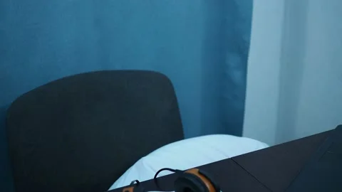 A boy in a shirt doing homework at the table. he drops the pencil on the floor Stock Footage 144181212