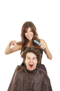 Boy shocked with face expression with long hair at smiling female hairdresser Stock Photos