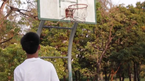 A boy shooting a ball Stockbeeldmateriaal 104744770