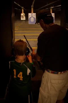 Boy at Shooting Range with Teacher Stock Photos